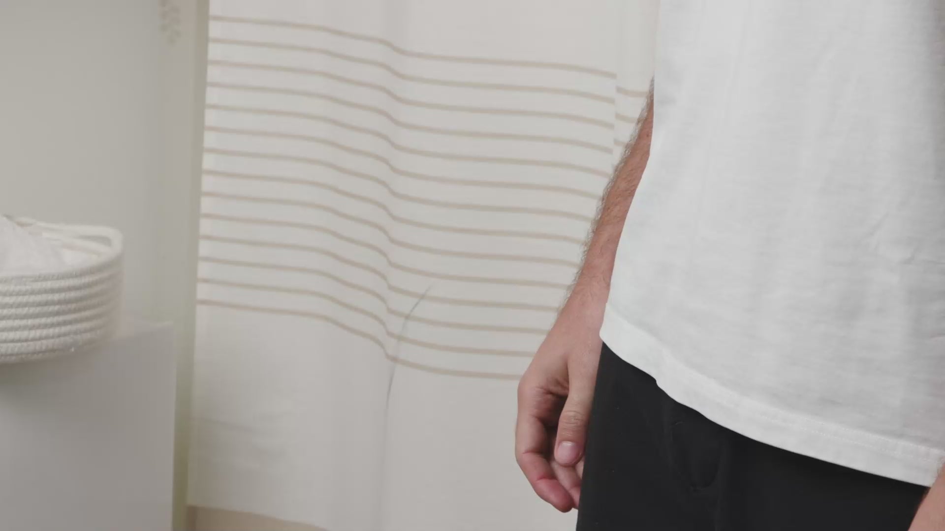A man refilling a Purefill whole body deodorant container in a bathroom