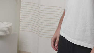 A man refilling a Purefill whole body deodorant container in a bathroom